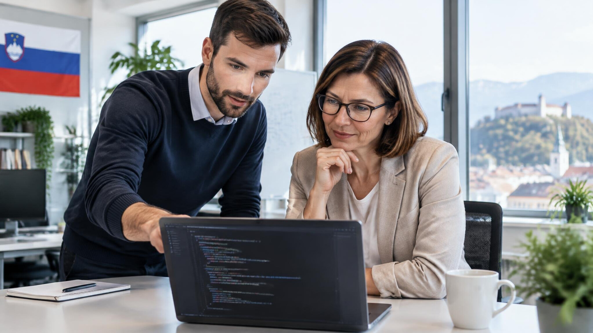Business team reviewing code on a laptop in a modern office
