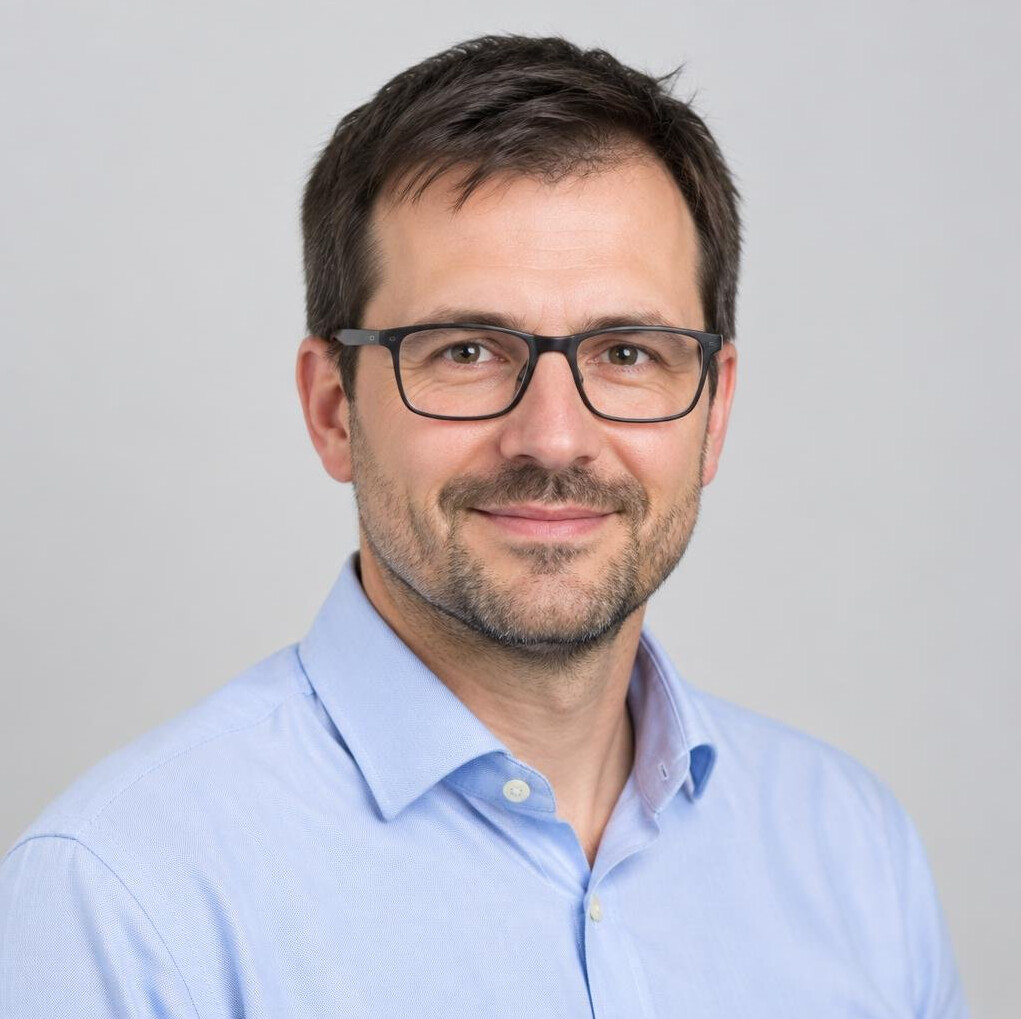 Studio portrait of a Slovenian man with glasses
